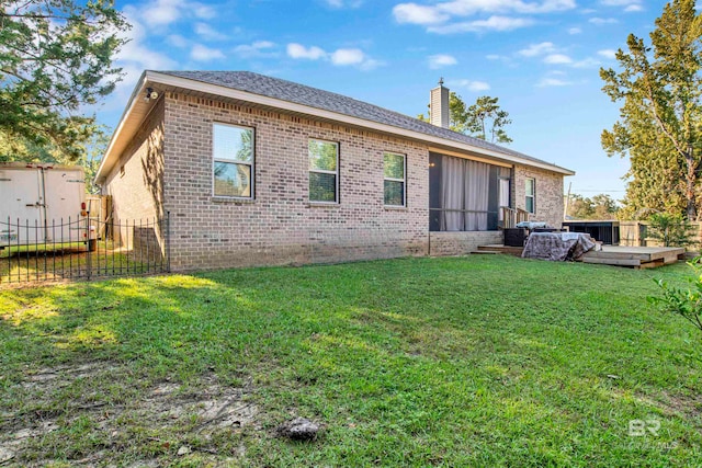 back of house featuring a deck and a yard