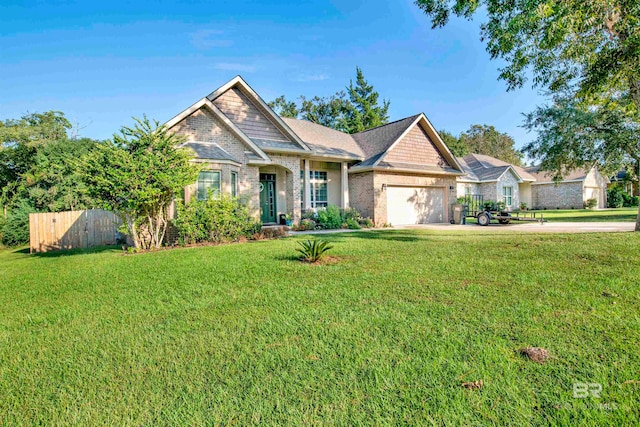 craftsman house with a garage and a front lawn