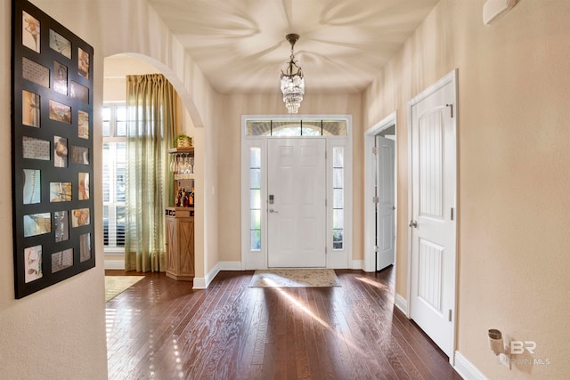 entrance foyer featuring dark hardwood / wood-style floors and a chandelier