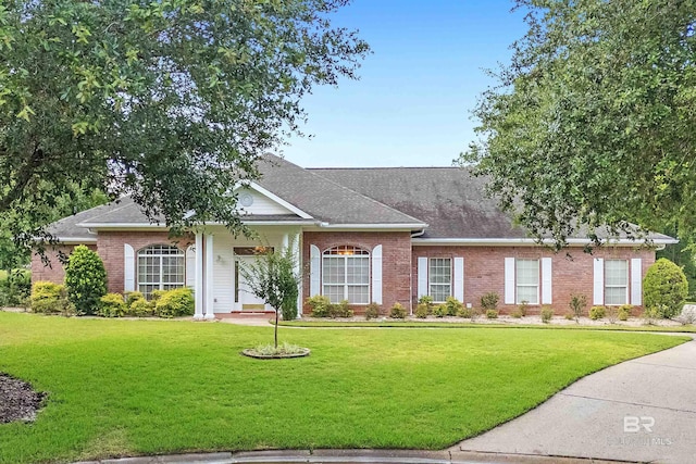 715 Village Dr, Gulf Shores, AL 36542 - single story home with brick siding, a front yard, and roof with shingles