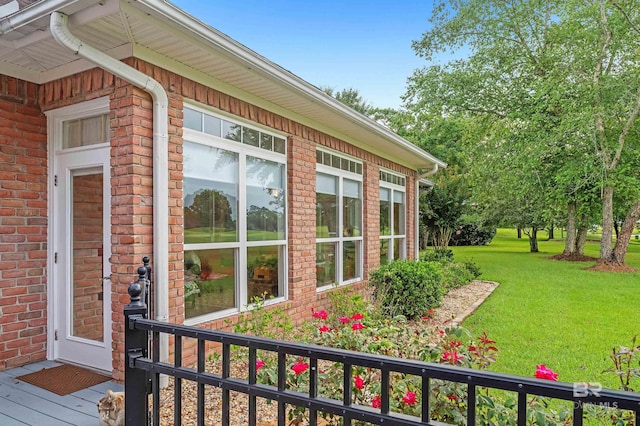 715 Village Dr, Gulf Shores, AL 36542 - view of property exterior with a yard and brick siding