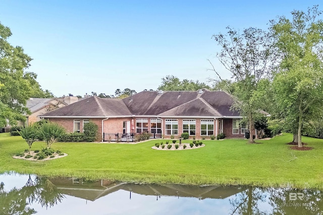 715 Village Dr, Gulf Shores, AL 36542 - back of house featuring a yard, brick siding, and a water view