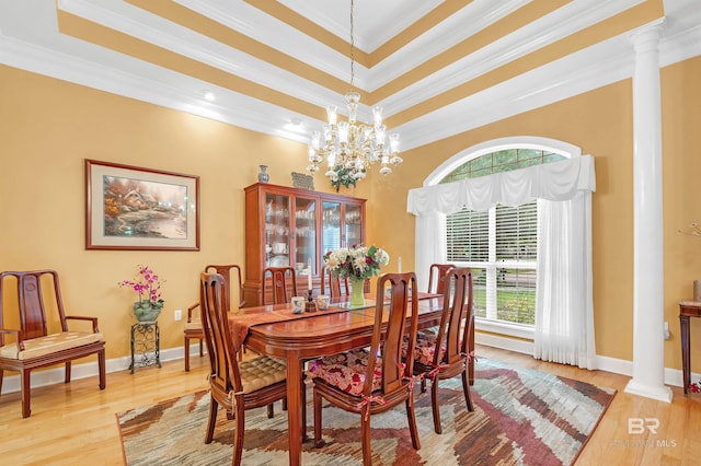 715 Village Dr, Gulf Shores, AL 36542 - dining space featuring plenty of natural light, ornamental molding, light wood finished floors, a raised ceiling, and ornate columns