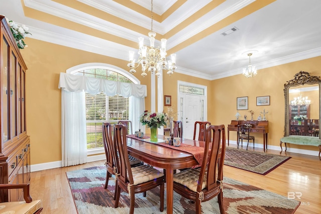 715 Village Dr, Gulf Shores, AL 36542 - dining space featuring a chandelier, light wood-style flooring, and crown molding