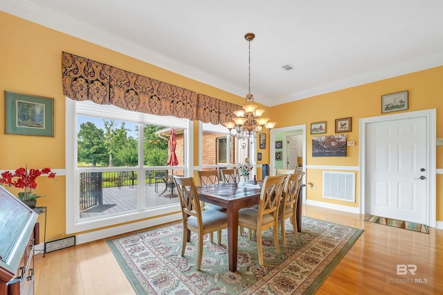 715 Village Dr, Gulf Shores, AL 36542 - dining space featuring a chandelier, light wood-type flooring, and ornamental molding