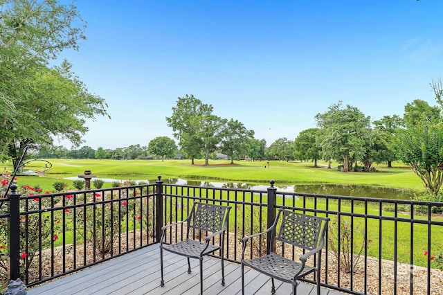 715 Village Dr, Gulf Shores, AL 36542 - wooden deck with a water view, view of golf course, and a lawn