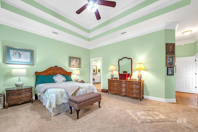 715 Village Dr, Gulf Shores, AL 36542 - bedroom with carpet, ornamental molding, a tray ceiling, a ceiling fan, and ensuite bathroom