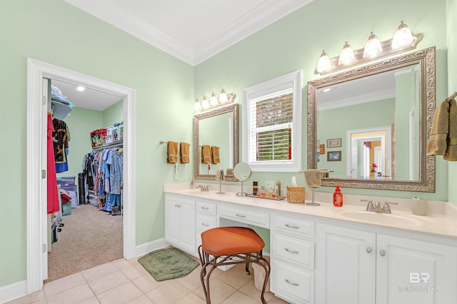 715 Village Dr, Gulf Shores, AL 36542 - bathroom with double vanity, ornamental molding, tile patterned flooring, and a spacious closet