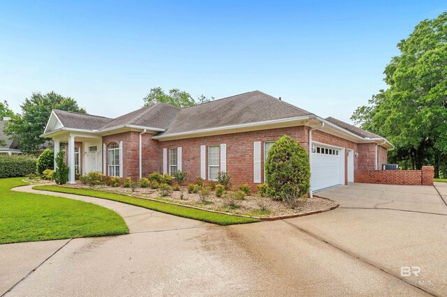 715 Village Dr, Gulf Shores, AL 36542 - single story home with brick siding, driveway, an attached garage, a shingled roof, and a front lawn