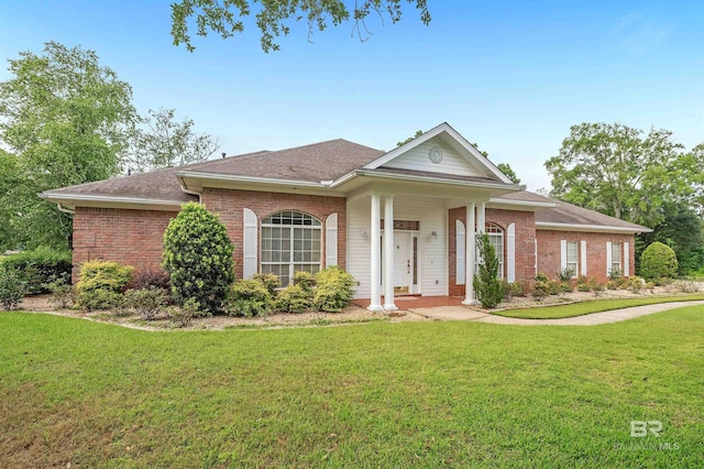 715 Village Dr, Gulf Shores, AL 36542 - view of front of property featuring brick siding, a front yard, and a shingled roof