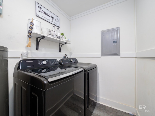 laundry room with washing machine and clothes dryer, ornamental molding, dark hardwood / wood-style floors, and electric panel