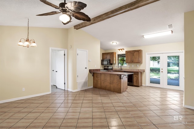 kitchen featuring hanging light fixtures, a kitchen breakfast bar, vaulted ceiling with beams, kitchen peninsula, and light tile patterned floors