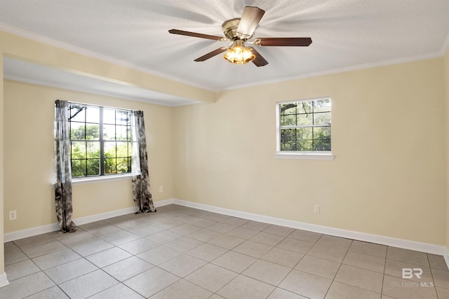 tiled empty room featuring ceiling fan, ornamental molding, and a textured ceiling