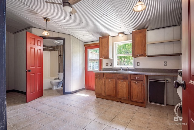 kitchen with wood ceiling, vaulted ceiling, ceiling fan, sink, and pendant lighting