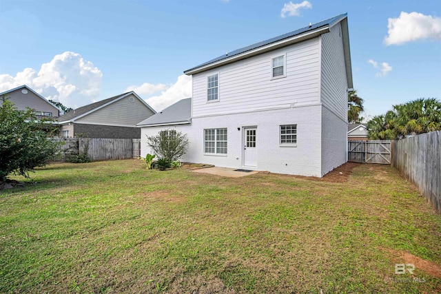 1126 Sloane Cv, Foley, AL 36535 - rear view of property with brick siding, a patio area, and a gate