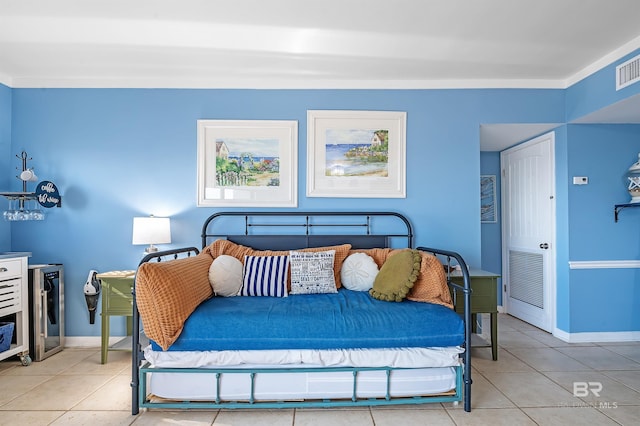 tiled bedroom featuring baseboards