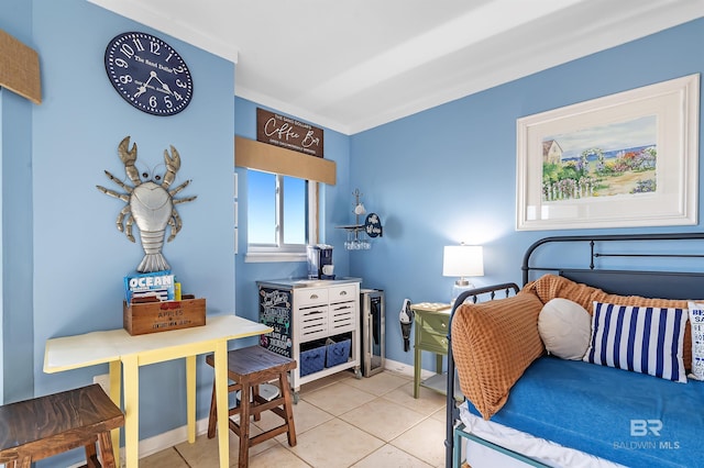 bedroom with light tile patterned floors and baseboards