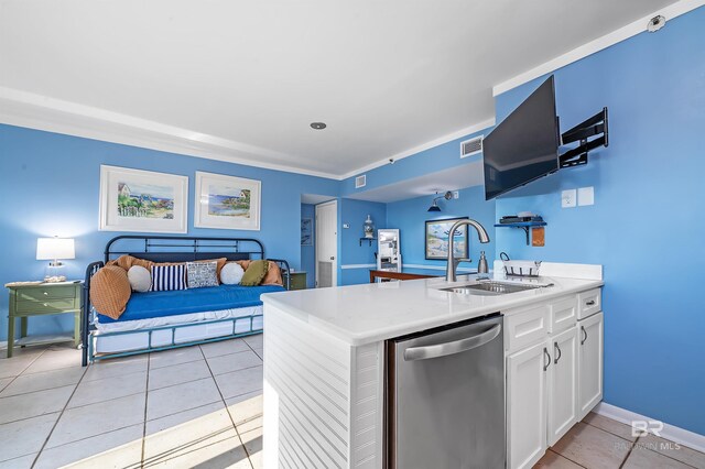 kitchen featuring light tile patterned floors, stainless steel dishwasher, kitchen peninsula, sink, and white cabinets