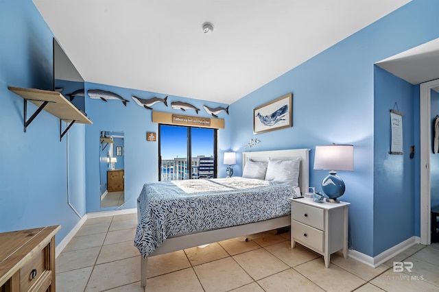 bedroom with light tile patterned flooring and baseboards