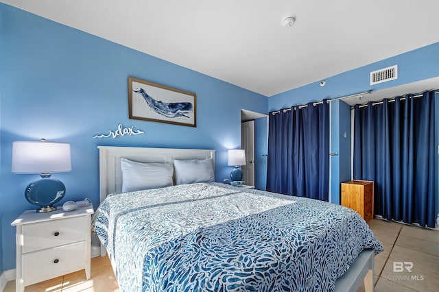 bedroom featuring tile patterned floors and visible vents