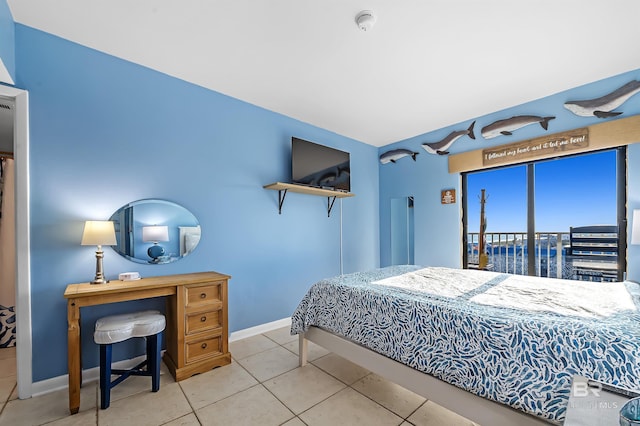 tiled bedroom featuring baseboards