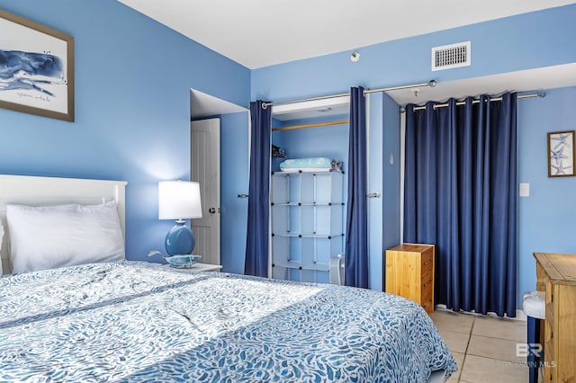 bedroom with tile patterned floors and visible vents
