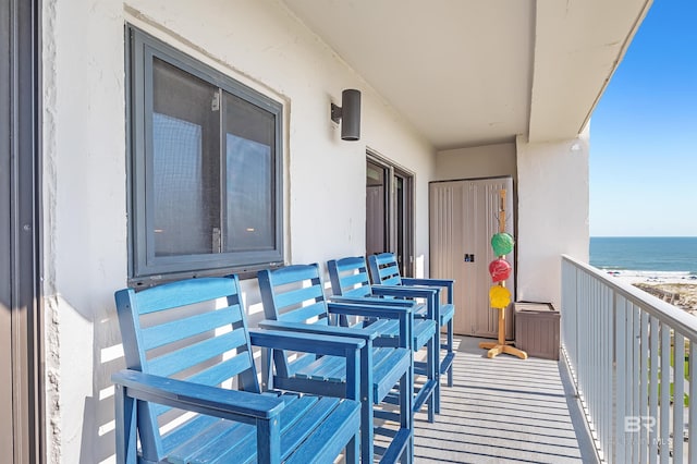 balcony featuring a water view and a beach view
