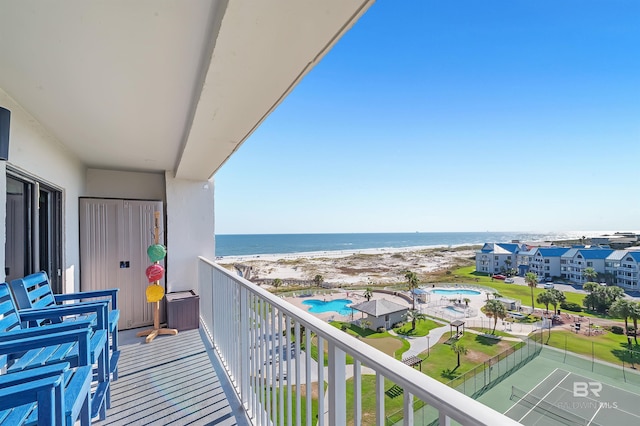 balcony featuring a water view and a view of the beach