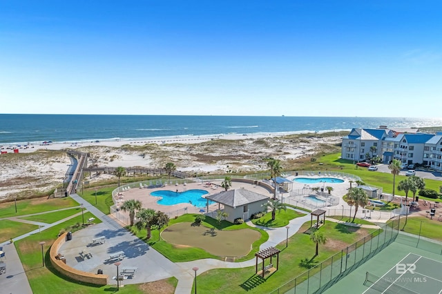 drone / aerial view with a beach view and a water view