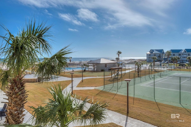 view of sport court with a lawn