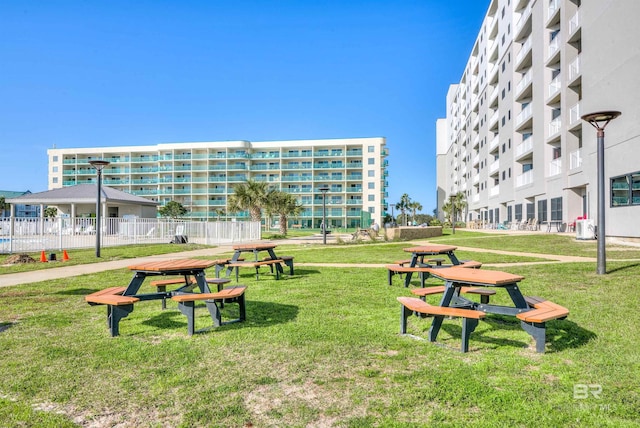 view of home's community featuring a lawn and fence