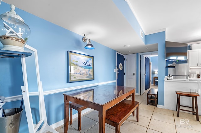 dining room with light tile patterned flooring, baseboards, and visible vents