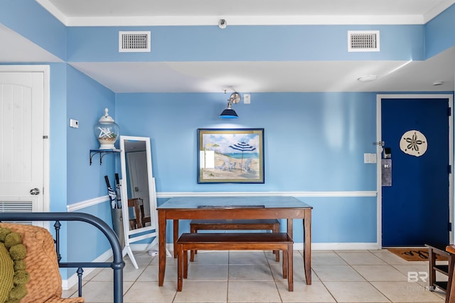 dining area featuring baseboards, visible vents, and tile patterned flooring