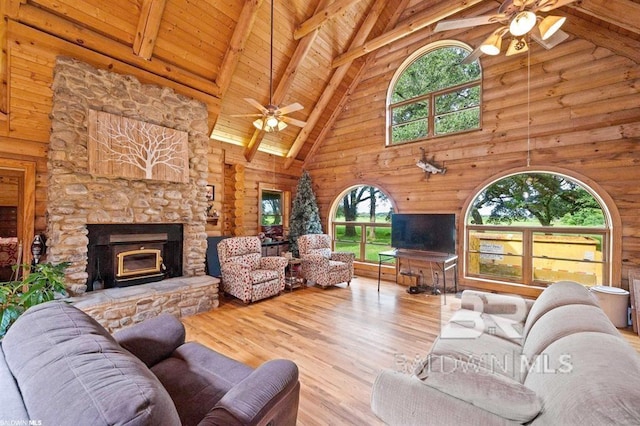 living room featuring ceiling fan, light wood-type flooring, and plenty of natural light