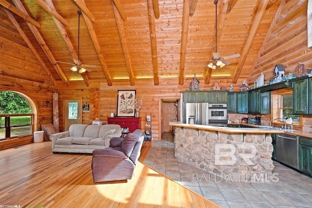 interior space featuring ceiling fan, appliances with stainless steel finishes, wood ceiling, and light hardwood / wood-style floors