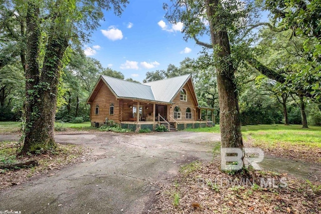 log cabin with a porch
