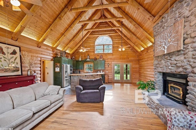 living room with high vaulted ceiling, log walls, light wood-type flooring, wood ceiling, and a stone fireplace