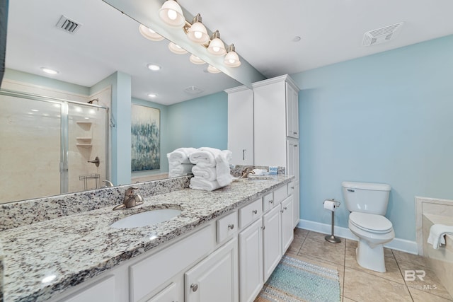 bathroom with vanity, tile patterned floors, toilet, and walk in shower