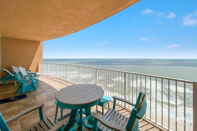 balcony with a beach view and a water view