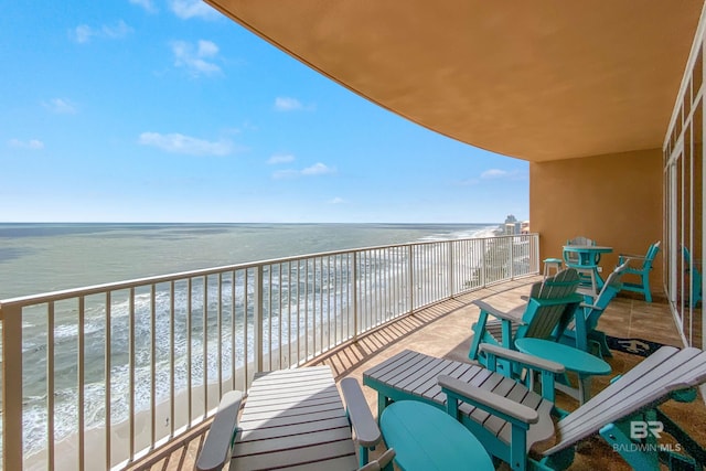 balcony with a water view and a beach view