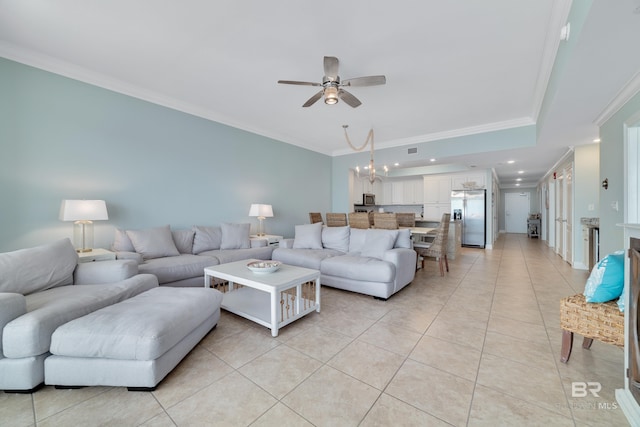 living room with ornamental molding, ceiling fan with notable chandelier, and light tile patterned floors