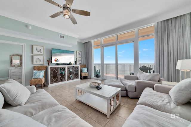 tiled living room with ornamental molding and ceiling fan