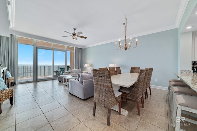 tiled dining space featuring ceiling fan with notable chandelier, ornamental molding, and floor to ceiling windows