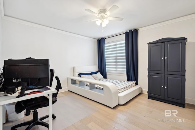 bedroom featuring ceiling fan, light hardwood / wood-style flooring, and crown molding