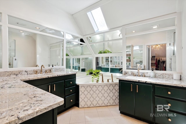 bathroom with tile patterned flooring, vanity, and lofted ceiling with skylight