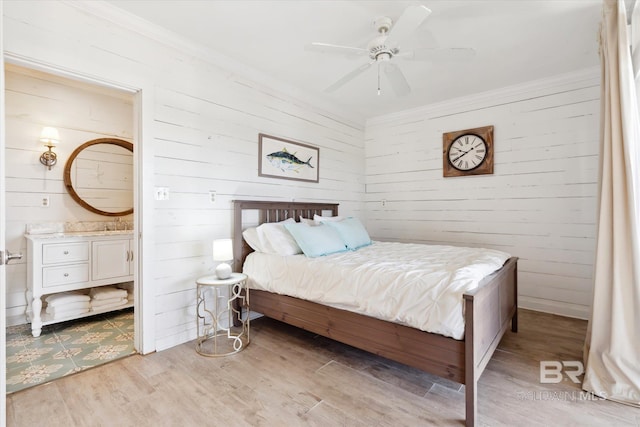 bedroom with ceiling fan, ornamental molding, and light wood-type flooring