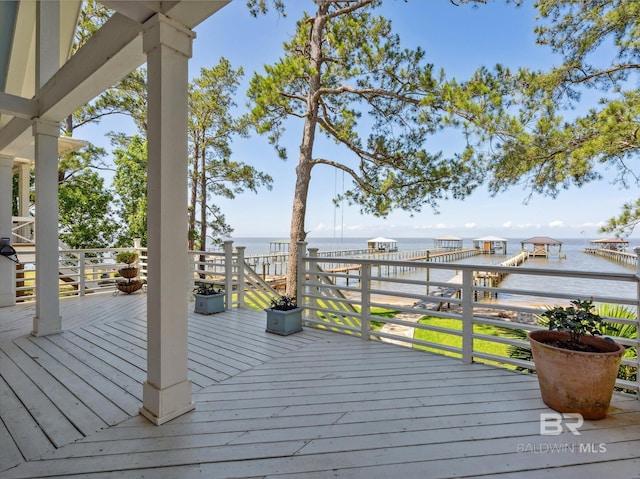 wooden terrace featuring a water view