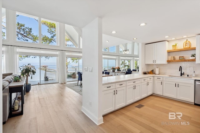 kitchen with sink, white cabinets, and light hardwood / wood-style floors