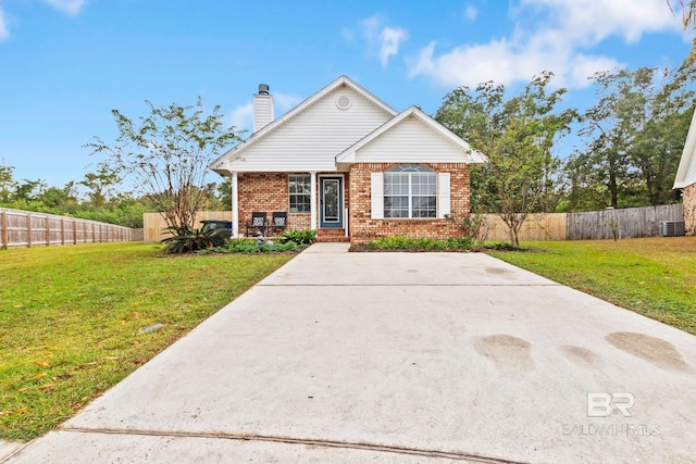 view of front of home with a front yard and central AC unit