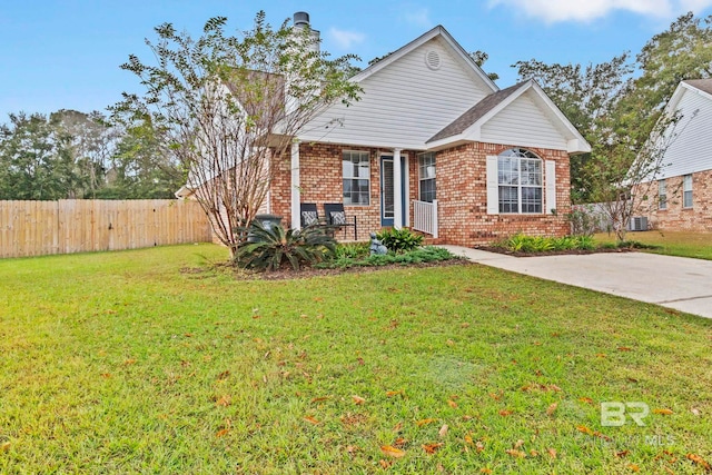 view of front of house with cooling unit and a front lawn